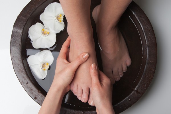 Feet in a bowl of water getting massaged